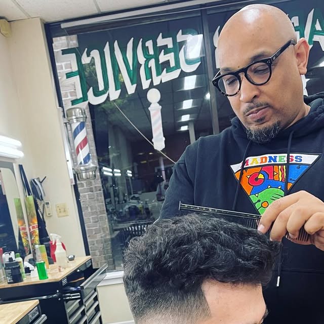 Barber working on a cut at Greene's Barber Service