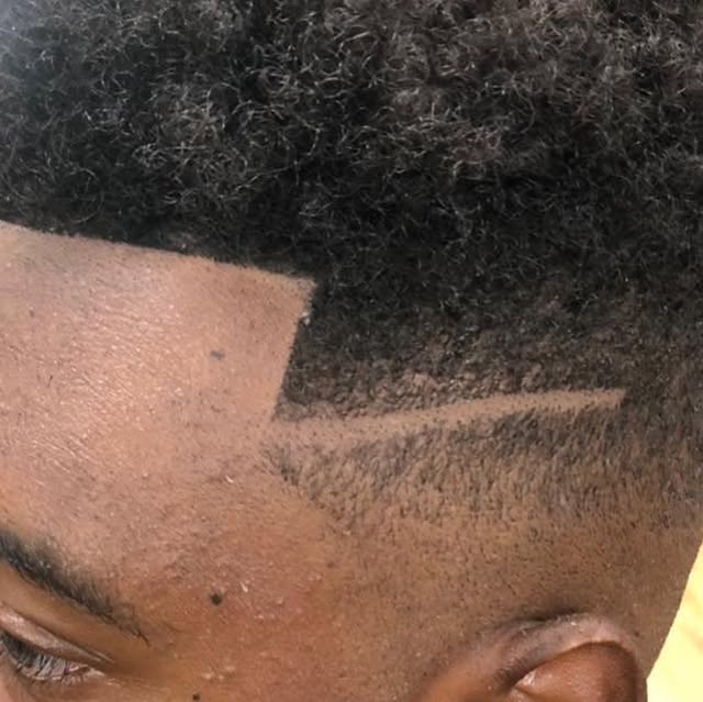 Sharp high fade with line design at Greene's